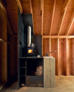 Inside, a Cubic Mini wood stove warms the cozy 8' x 12' space.