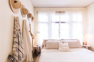 Zee's bedroom is filled with her hat collection as well as a wood knot from Katie Gong, the most represented of artists in her space, and hanging bells from Mudpuppy Ceramic Studio.