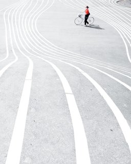Bicyclist at Superkilen public park in the Nørrebro district of Copenhagen, Denmark.