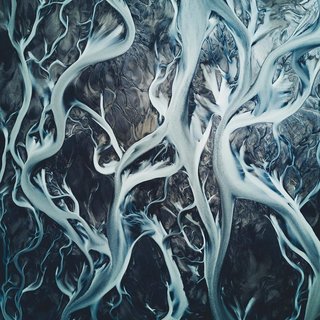 An aerial view of daily changing glacier rivers channeling their way through the highlands of Iceland. 