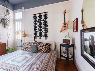 The guest bedroom oozes retro vibes and features a "circuit board" wall hanging by Windy.