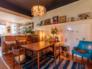The kitchen is bursting with art, including a triptych from Jeremiah Maddock.