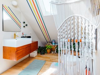 Windy's bathroom upstairs showcases the same stripes, as well as an array of plants and a porcelain deer nestled in the foliage. 