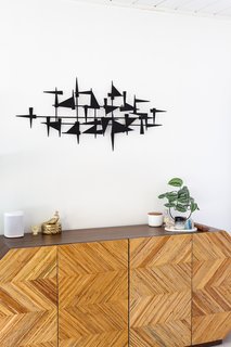 "I can’t help but giggle every time I see the bedroom credenza because Jon was so hesitant about it," says Encarnacion. "He felt it was too 'extra.' I was like, 'Come on, we’re grown-ass folks—we need something fun and bold. The moment it arrived, he was like, 'You know, I really love it.'"