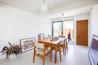 The dining room holds framed art, including a photo by her husband, that they've been meaning to hang.