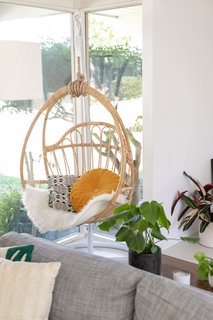 A hanging rattan chair is often used as a reading nook. 