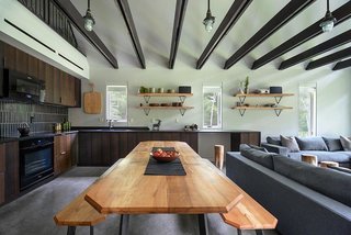 In the kitchen, a Heath-tiled backsplash sits over leathered granite counters. Smoked-oak cabinet doors from Reform cover Ikea cabinets. 