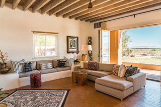 An entire wall opens up to the landscape for streamlined indoor/outdoor living.