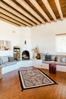 Three kiva fireplaces—and a large collection of rugs and textiles—offer warmth on cold desert nights.