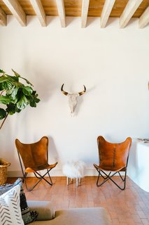 The 18-inch-thick adobe walls keep the house cool in the summer and cozy in the winter. An animal-themed nook situated next to a fiddle-leaf fig calls to mind a safari adventure.