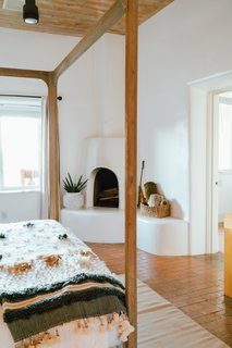 A fireplace in the master bedroom features built-in seating.