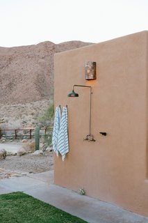 An outdoor shower welcomes Young home after a day out in the dunes.