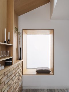 A large window adds natural light to the space and doubles as a seat. 