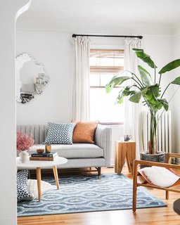 Francois adds pattern to the living room with pillows and a hand-knotted wool rug by Sylvie and Mira, inspired by original watercolor art.