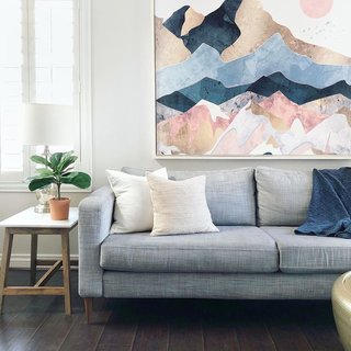 Rose kept the living room airy with an IKEA sofa with updated legs and a hanging wall tapestry. 