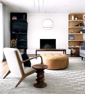 Clare Conklin's living room features subtle earth tones and a mix of wood finishes.