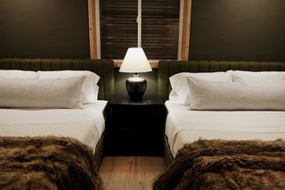 Despite the fact that this bedroom has no natural light, Julia opted to go with a dark paint color and moody decor to create a modern, rustic vibe. Surprisingly, all pieces are from Walmart—including the Novogratz Brittany upholstered bed, the Best Home Fashion Wild Mannered long hair faux fur throw, and the AF Lighting Danbury textured ceramic table lamp.