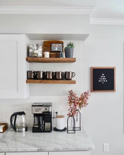 Laura keeps it airy in the kitchen with an alabaster palette and open shelving.