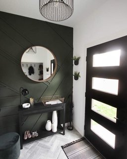 The entryway is textured with a wood accent wall and chevron flooring.