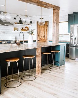 Holman's kitchen blends textures and rich hues with Waltz counter stools from McGee & Co and a Luna pendant from Schoolhouse.