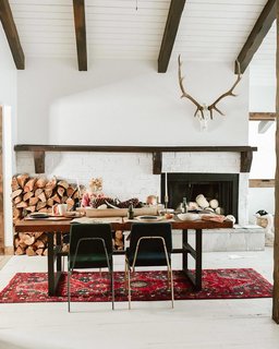 Drawing inspiration from Sweden, Holman set mismatched chairs at the dining table that are just similar enough.