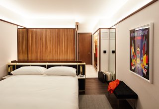 The hotel features custom-built millwork crafted in Ohio’s Amish Country—including walnut martini bars and tambour walls, as seen here. All specialty pieces are created from locally grown walnut trees.