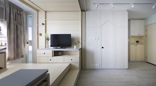 The tiny apartment is filled with clever space-saving solutions, including built-in storage and transforming furniture.