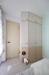 The mother's bedroom cabinet holds a built-in cat house.