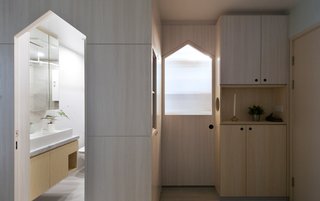 Clean lines and an airy palette continue in the bathroom.