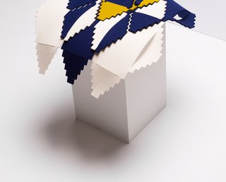 Pala is a three-dimensional wall sculpture composed of interlocking modular pieces. The shape is reminiscent of traditional weaving ornamentation.