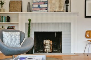This midcentury modern home that dates from 1952 was given a fresh renovation before it was put back on the market. The happy, modern home gives a nod to its original construction with details like a fireplace with painted grey bricks and white mantel. 