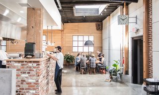 The serving line of Proud Mary’s large, open kitchen was created using handmade maple shelves and the building's original 1920s brick.