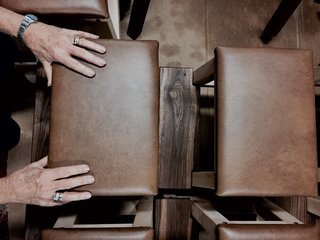 Handmade walnut stools were crafted by Hirte’s father Bob, and upholstered using locally sourced leather by his mother Josie. 