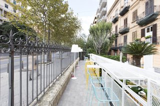 A look at the white iron grids that form tabletops and dividing screens in the outdoor area.