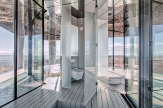 Go Stargazing in This Off-Grid Glass Prefab Nestled in the Desert - Photo 9 of 13 - The bathroom is concealed behind a slim door.