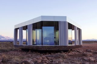 Go Stargazing in This Off-Grid Glass Prefab Nestled in the Desert - Photo 1 of 13 - Gorafe desert is known for its extreme temperatures and stunning rock formations. Thanks to the mirrored panels that clad the edges of the roof and deck, stunning views are available at every angle of this prefab rental.