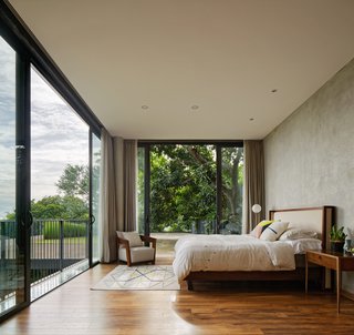 The bedroom on the second floor has a treehouse-like feel.