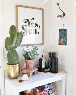 A Couple Spend $3K to Turn an Old RV Into a Cozy Home For Five - Photo 4 of 10 - Pops of greenery and art imbue warmth into the tiny home.