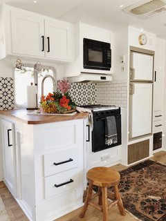 A Couple Spend $3K to Turn an Old RV Into a Cozy Home For Five - Photo 7 of 10 - The compact kitchen features a ceramic tile backsplash.