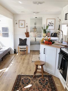 A Couple Spend $3K to Turn an Old RV Into a Cozy Home For Five - Photo 1 of 10 - A peek inside the RV after the revamp. The couple spent three weeks renovating the space and did most of the work themselves. "My husband had worked in construction a little so he had a general background of basic things and we just figure out how to do things if we don't know how," explains Ashley.