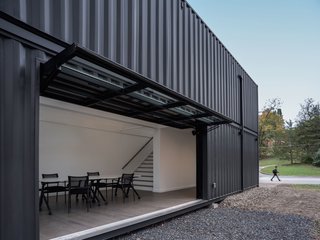 A Shipping Container Prefab Lab Is Built in Only 4 Hours - Photo 5 of 12 - The Media Lab has been painted black to recede into the woods.