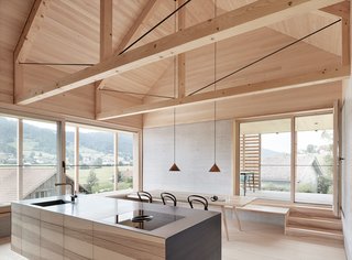A Minimalist Home Is Built Into Steep Terrain in an Austrian Valley - Photo 2 of 13 - Exposed trusses celebrate the home's timber construction. The house is also equipped with solar water heating.
