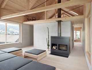 A Minimalist Home Is Built Into Steep Terrain in an Austrian Valley - Photo 6 of 13 - A small seating area is tucked into a loft-like space.