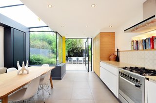 The fridge is tucked behind the bespoke oak cupboard.