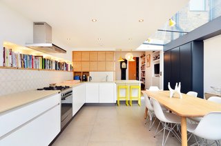 A long bookshelf lines the space above the Caesarstone Bondi countertops.