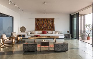 A tree-stump end table adds a dose of organic style to the modern living area.