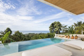 The infinity pool mirrors the Pacific Ocean.