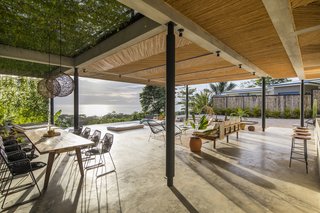 Climbing vines form a green wall and ceiling in the communal lounge area, providing some privacy without disturbing the natural setting.