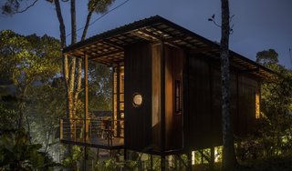 A ‘porthole’ window offers a glimpse of the outdoors from the shower area.