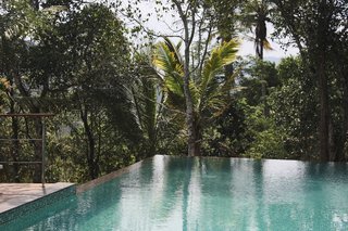 A nearly 50-foot-long infinity pool, also raised on stilts, overlooks views of the striking cardamon plantations.